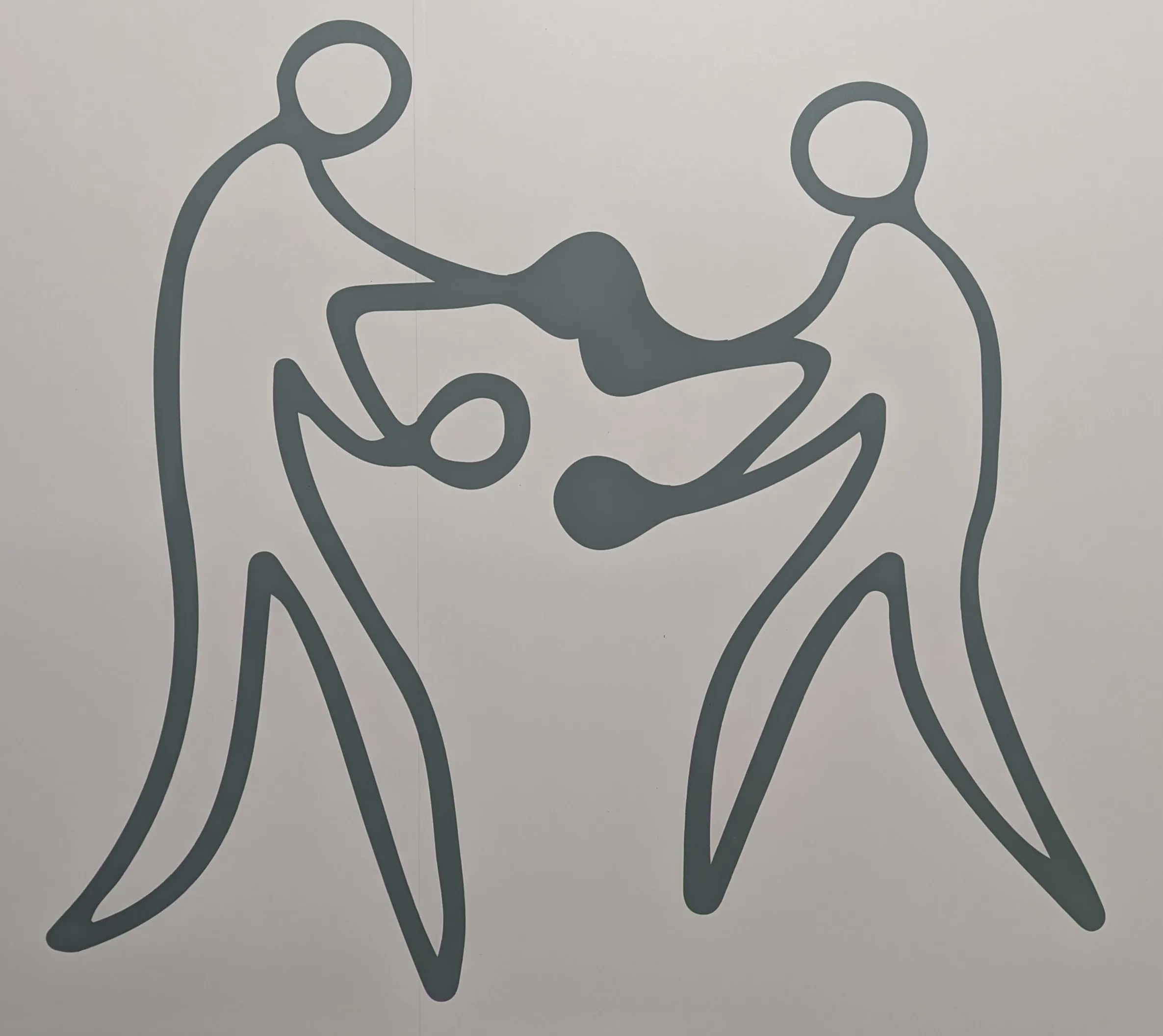 Two people facing off wearing boxing gloves