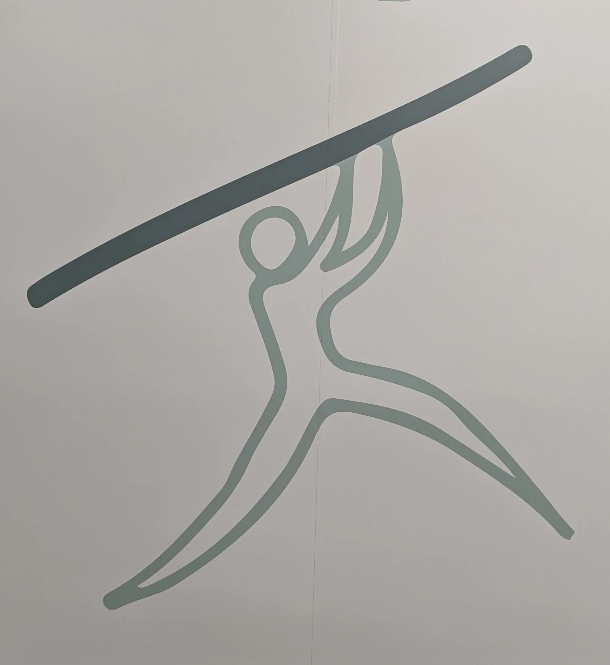 A person holding a stick with both hands, 1/3 of the way up the pole